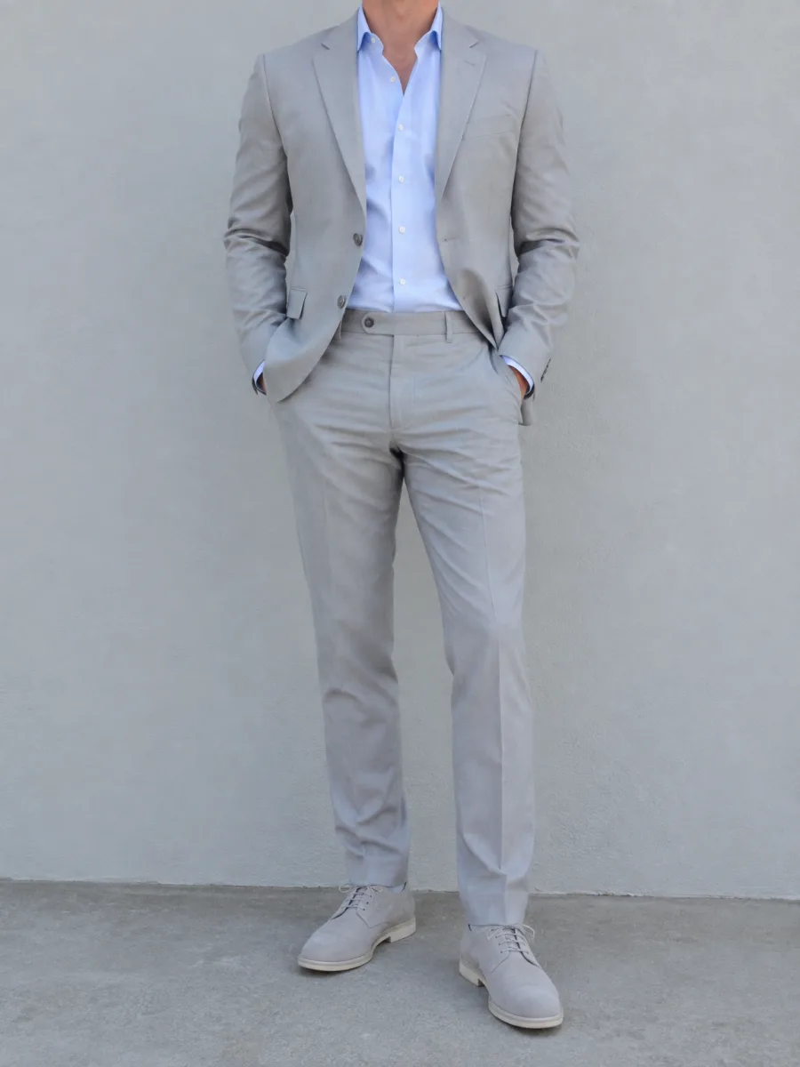 Man in a light cool grey suit with a pale blue shirt
