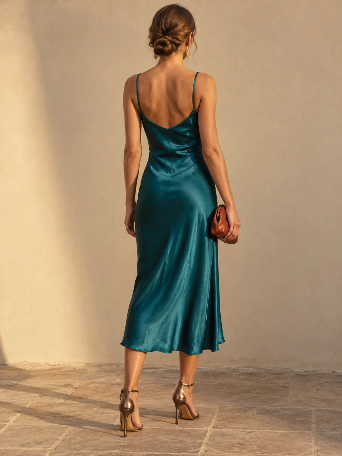 Warm Autumn evening outfit: teal satin dress with bronze heels and a terracotta clutch